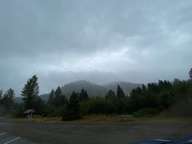 The cloudy mountaintops from the parking lot